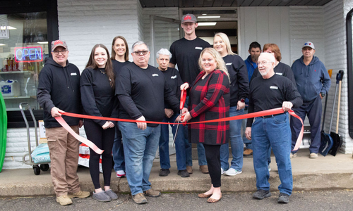 Employees cutting grand opening ribbon